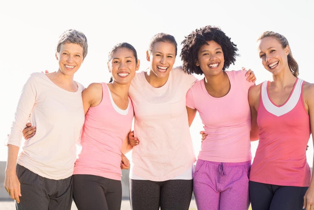 A group of women hugging and smiling